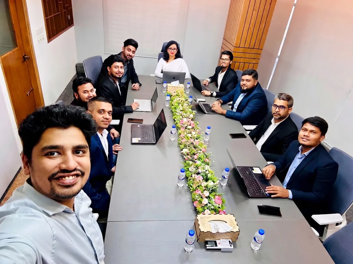 The CodeFix IT team working on laptops around a meeting table